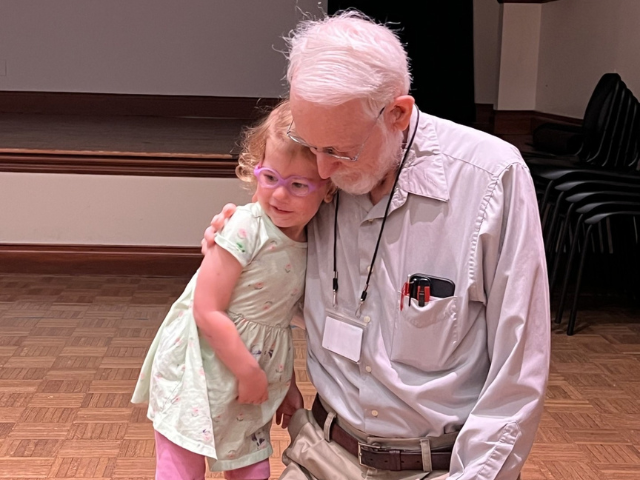older man and child in embrace