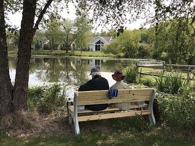 couple on bench near pond