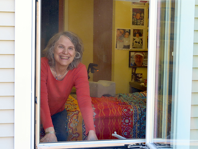 older woman looking out window