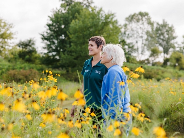 two women gazing at wildflowers