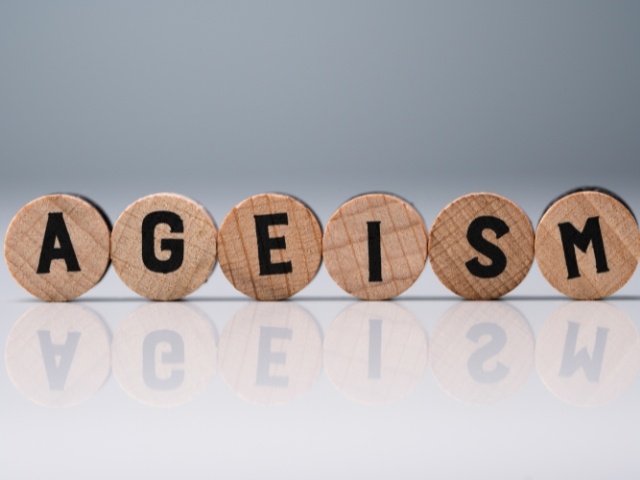 Ageism text on round wooden blocks