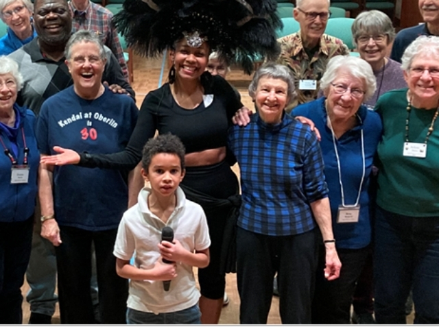 group of people with a woman dressed to lead a Samba