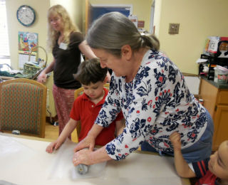 Older woman doing making something with a child