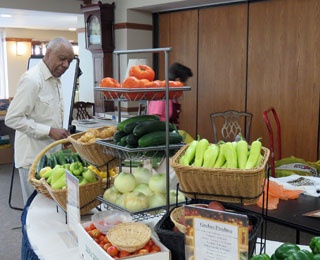 man looking at fresh vegetables on a table