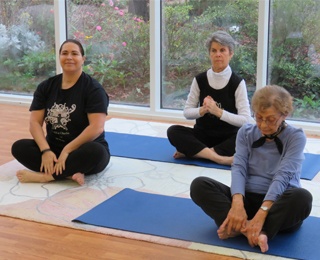 older adult women doing yoga