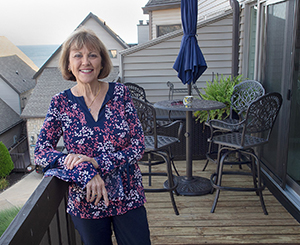 maggie standing on balcony after downsizing home